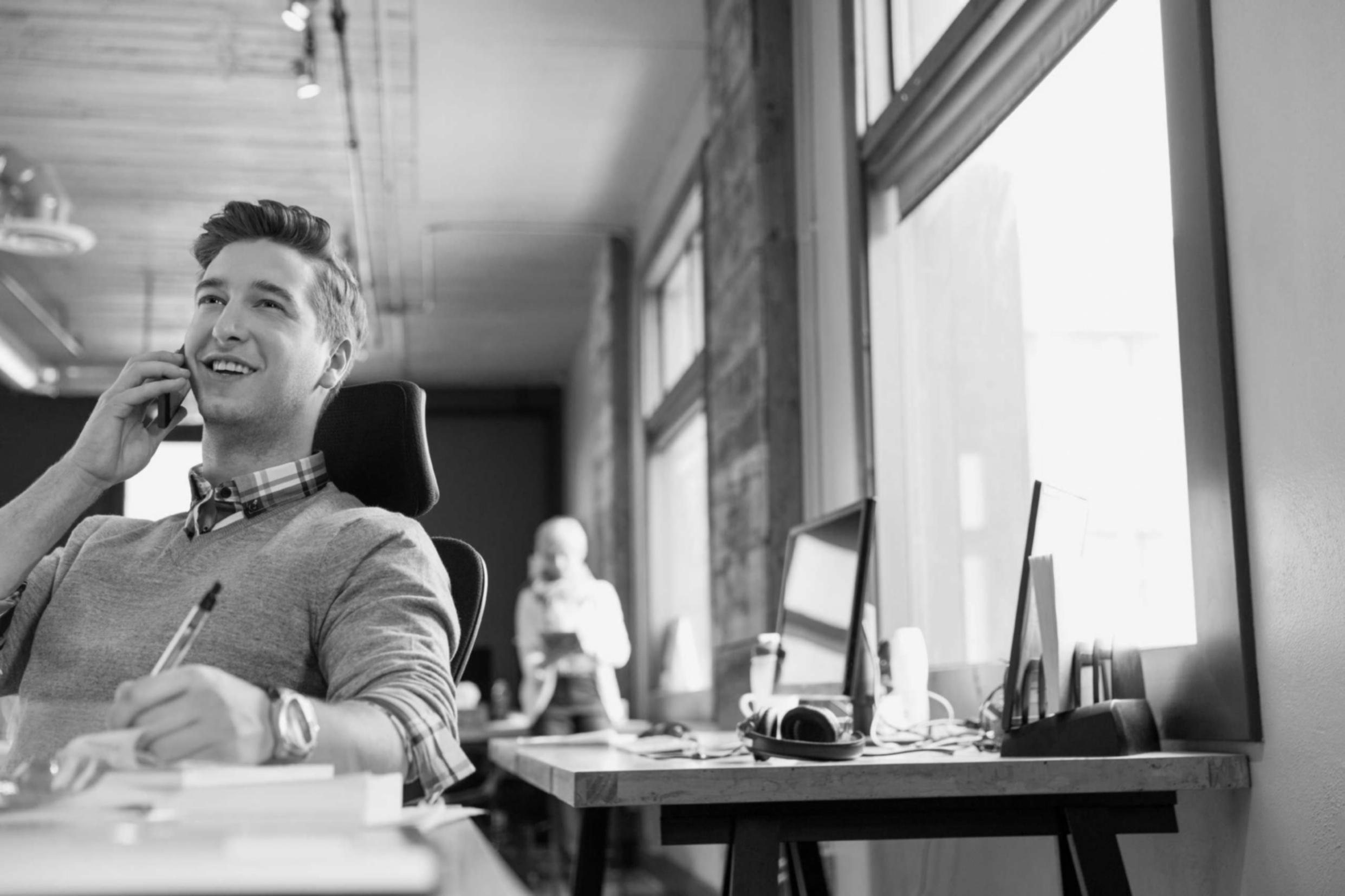 Student analyzing investment data on multiple screens